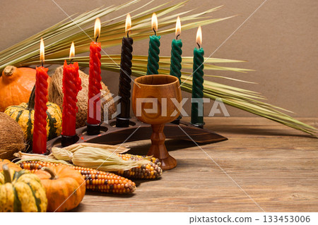 Kwanzaa Celebration Setup. A festive Kwanzaa display with candles, fruits, and decorative elements 133453006