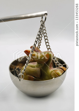 Jade rabbit figurine on balance scale symbolizing value weighing closeup. 133453268