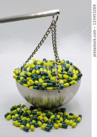 Capsules on balance scale symbolizing medical weight Capsules on balance scale symbolizing medical weight 133453269