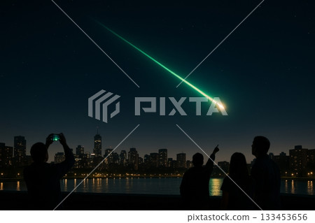 A green meteor streaks over a night city skyline as silhouetted watchers point and take photos by the water. Concept of cosmic awe and shared stargazing. For event poster 133453656