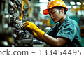 Worker in a factory wearing a hard hat and gloves, focusing on machinery. Concept of industrial labor. For industry and work safety promotion. 133454495