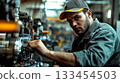 Worker wearing a cap operating machinery in a workshop, focused and attentive. Concept of industrial work, craftsmanship. For illustrating industrial work theme 133454503