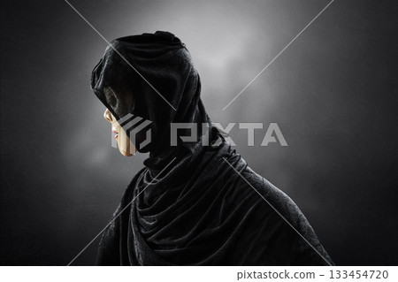 Scary lady with hooded cloak in the dark Scary lady with hooded cloak in the dark 133454720