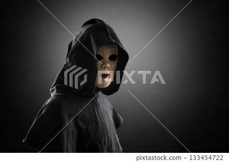 Scary lady with hooded cloak in the dark Scary lady with hooded cloak in the dark 133454722