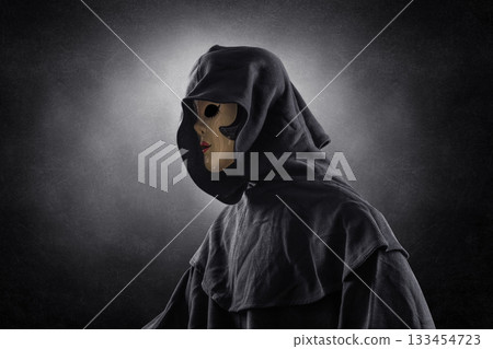 Scary lady with hooded cloak in the dark 133454723