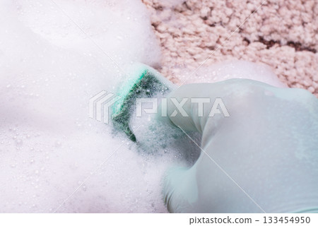 Spring cleaning in house. Cleaning beige rug by carpet and upholstery shampoo with foam Spring cleaning in house. Cleaning beige rug by carpet and upholstery shampoo with foam 133454950