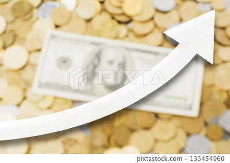 White arrow showing upward direction, against golden, silver coins and one hundred US dollar banknote at the background White arrow showing upward direction, against golden, silver coins and one hundred US dollar banknote at the background 133454960
