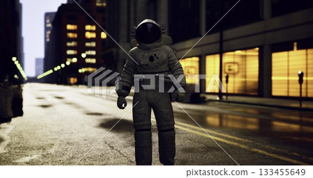 An astronaut stands solitary in a deserted city street illuminated by dim streetlights. Surrounding buildings reflect soft lights under the night sky. An astronaut stands solitary in a deserted city street illuminated by dim streetlights. Surrounding buildings reflect soft lights under the night sky. 133455649