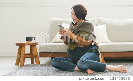 Woman operating a mobile phone 133455920