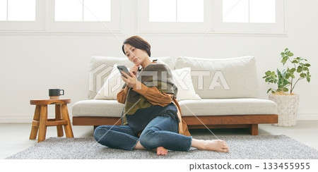 Woman operating a mobile phone 133455955