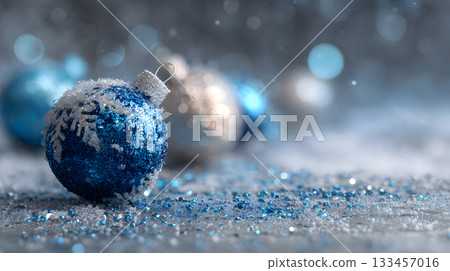 Bright blue and silver Christmas ornaments on a snowy surface with sparkling decorations Bright blue and silver Christmas ornaments on a snowy surface with sparkling decorations 133457016