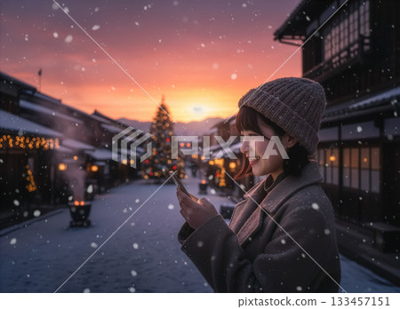 Woman looking at smartphone, illuminations, outdoors Woman looking at smartphone, illuminations, outdoors 133457151
