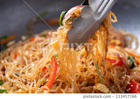 Japchae, Korean stir fried glass noodles with vegetables, pork, soy sauce and sesame oil Japchae, Korean stir fried glass noodles with vegetables, pork, soy sauce and sesame oil 133457166