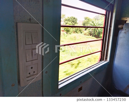Empty interior of the train for long and short distance in india train carriage with blue seats. beautiful nature view from train window Empty interior of the train for long and short distance in india train carriage with blue seats. beautiful nature view from train window 133457230