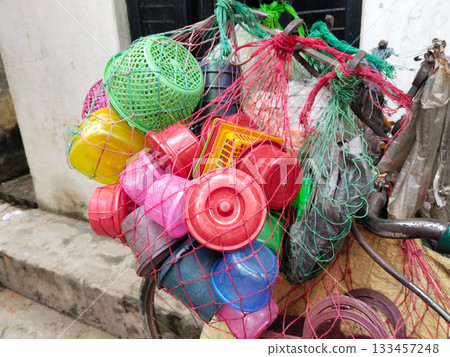 cycle vendor selling door to door in village. toy seller pedals his cycle, filled with colorful toys, spreading joy to kids in every street corner. 133457248