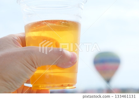 Hands and scenery toasting with draft beer Hands and scenery toasting with draft beer 133461131