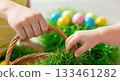 Children's hands reach for colorful Easter eggs in basket, anticipation grows 133461282