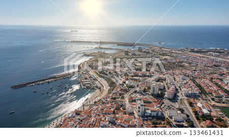sines portugal. sunset over calm coastal area featuring leisure activities and vessels, vivid aerial depiction of tranquil sines bay with sandy shores and boating sines portugal. sunset over calm coastal area featuring leisure activities and vessels, vivid aerial depiction of tranquil sines bay with sandy shores and boating 133461431