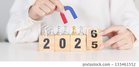 hand holding magnet and pulling man chess figure from the crowd employee with 2026 Year block. Human resource management, Recruitment, Teamwork, strategy, toxic people and leadership Concepts 133461552