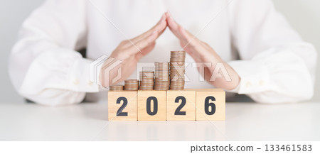 Happy New Year 2026 with hand cover money stack growing. Insurance, protection, safety and New year holiday Concepts Happy New Year 2026 with hand cover money stack growing. Insurance, protection, safety and New year holiday Concepts 133461583
