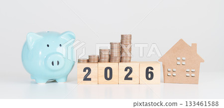 Happy New Year 2026 with house model and Coins stack. real estate, Home loan, tax, investment, mortgage, financial, savings and New Year Resolution concepts 133461588