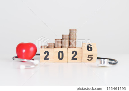 Happy New Year 2026 with doctor Stethoscope, coins stack and red heart on table. health care, Money saving, Goal, Resolution, health Insurance, Wellness and medical concept 133461593