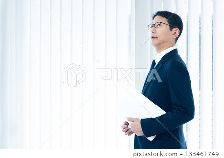 A businessman standing at the window 133461749