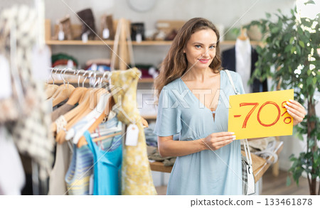 Woman holding poster with 70 percent discount Woman holding poster with 70 percent discount 133461878