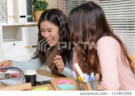 Young businesswomen busy meet office for financial work consult, team members collaborate reviewing documents, showing happy business professionals enjoying productive teamwork at workplace setting. 133461998