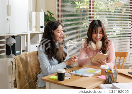 Young businesswomen busy meet, consult, and work together as team in modern office, engaged in financial discussion, analyzing documents, fostering successful business growth. 133462005