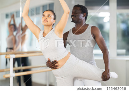 Adult man and young woman rehearsing pair ballet Adult man and young woman rehearsing pair ballet 133462036