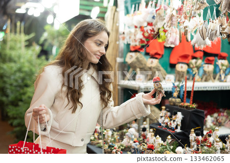 Woman choosing Christmas decorations 133462065