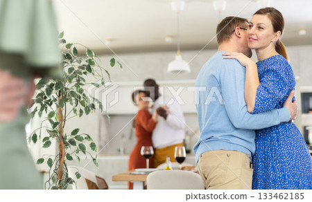 Woman sharing warm slow dance with man at house party 133462185