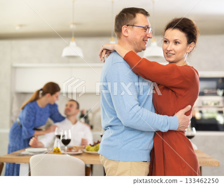 Woman sharing warm slow dance with man at house party Woman sharing warm slow dance with man at house party 133462250