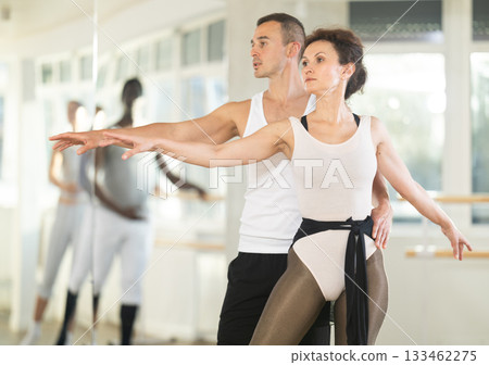 Young man and adult woman rehearsing pair ballet 133462275