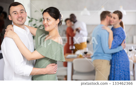 Men and women of different nationalities having fun dancing slow dance at house party 133462366