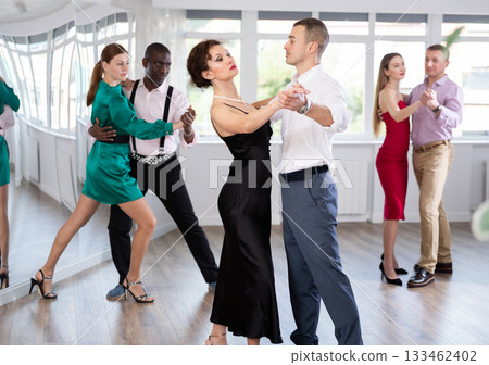 Woman and young man practicing waltz in dancing studio 133462402