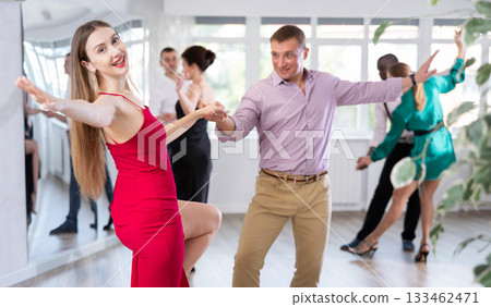 Woman dances incendiary boogie woogie with man partner during choreography lesson Woman dances incendiary boogie woogie with man partner during choreography lesson 133462471