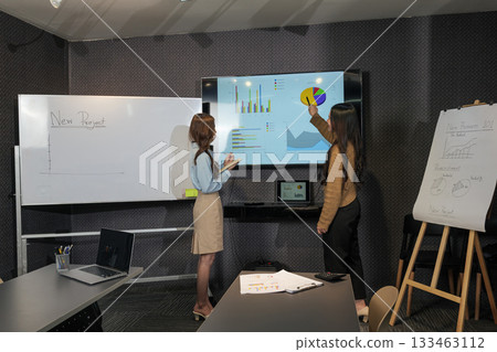 Business women meet, busy team people present new project work during important meeting, analyzing charts for successful business development and future plans. Business women meet, busy team people present new project work during important meeting, analyzing charts for successful business development and future plans. 133463112