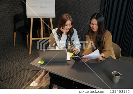 Business women meet, busy team people work on project, meeting in modern conference room, collaborating with laptop, documents, planning successful corporate strategy. Business women meet, busy team people work on project, meeting in modern conference room, collaborating with laptop, documents, planning successful corporate strategy. 133463125