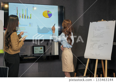 Business woman meeting work people team, busy reviewing project data presentation, analyzing market share, discussing company growth, planning strategies in conference room. Business woman meeting work people team, busy reviewing project data presentation, analyzing market share, discussing company growth, planning strategies in conference room. 133463144