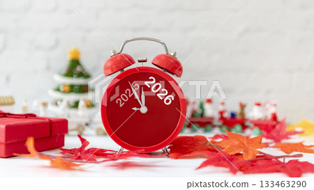 2025 and 2026 on red alarm clock on Christmas item background 133463290