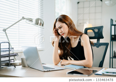 Angry woman stressed and overwhelmed at work, holding head in frustration at laptop, symbolizing office pressure, burnout, and deadline anxiety. Angry woman stressed and overwhelmed at work, holding head in frustration at laptop, symbolizing office pressure, burnout, and deadline anxiety. 133463478
