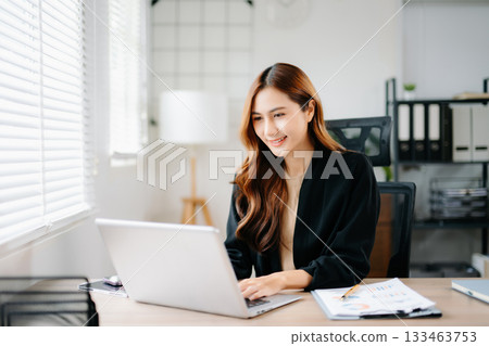 Business woman using tablet and laptop for doing math finance on an office desk, tax, report, accounting, statistics, and analytical research concept in office 133463753