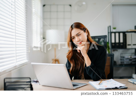 Business woman using tablet and laptop for doing math finance on an office desk, tax, report, accounting, statistics, and analytical research concept in office Business woman using tablet and laptop for doing math finance on an office desk, tax, report, accounting, statistics, and analytical research concept in office 133463755