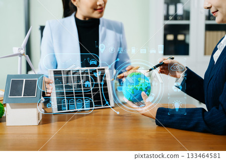 Business team working virtual modern smartphone to reduce CO2 emissions carbon footprint climate change to limit global warming.Sustainable development and green business concept. 133464581