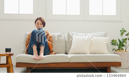 Woman operating a mobile phone Woman operating a mobile phone 133464864