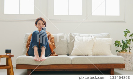 Woman operating a mobile phone Woman operating a mobile phone 133464868