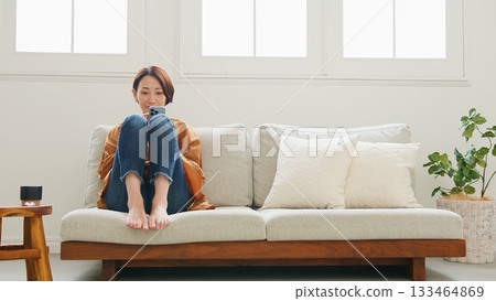 Woman operating a mobile phone 133464869