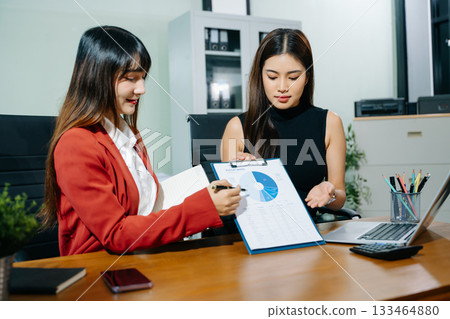 Business portrait two woman asian smile cheerful talk and holding tablet, computer with in agreement ready new project job for work in room office Business portrait two woman asian smile cheerful talk and holding tablet, computer with in agreement ready new project job for work in room office 133464880